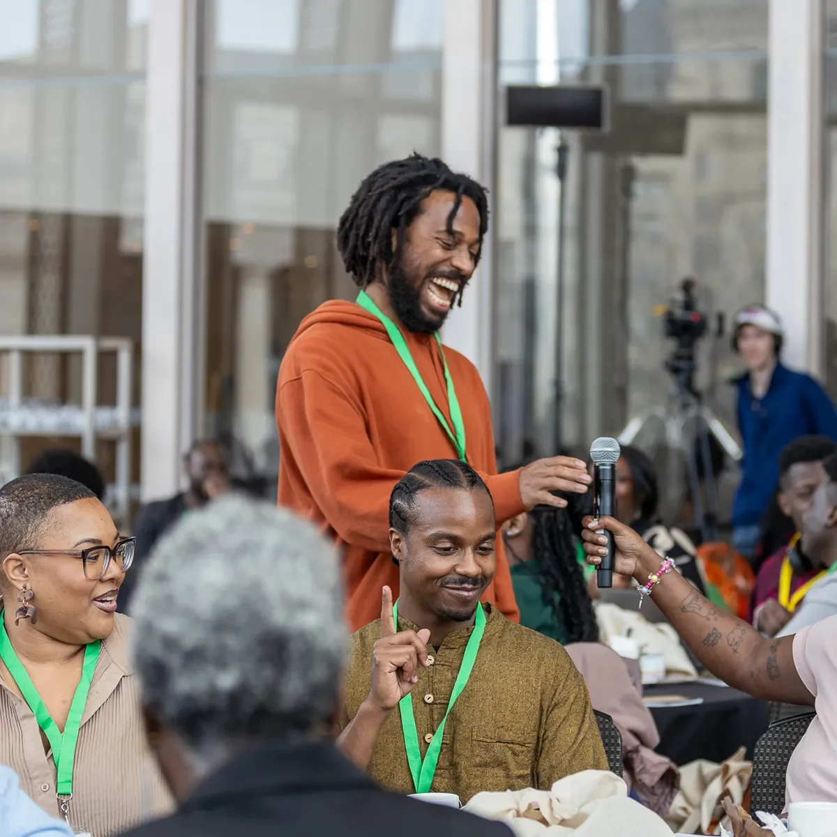 Group of people in discussion, smiling and engaging with each other in a collaborative setting